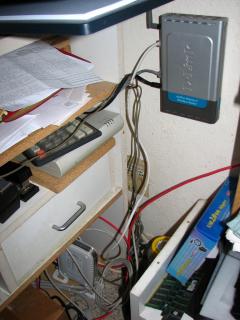 Wiring closet: DSL modem, wireless DSL router, and 1Gbps switch